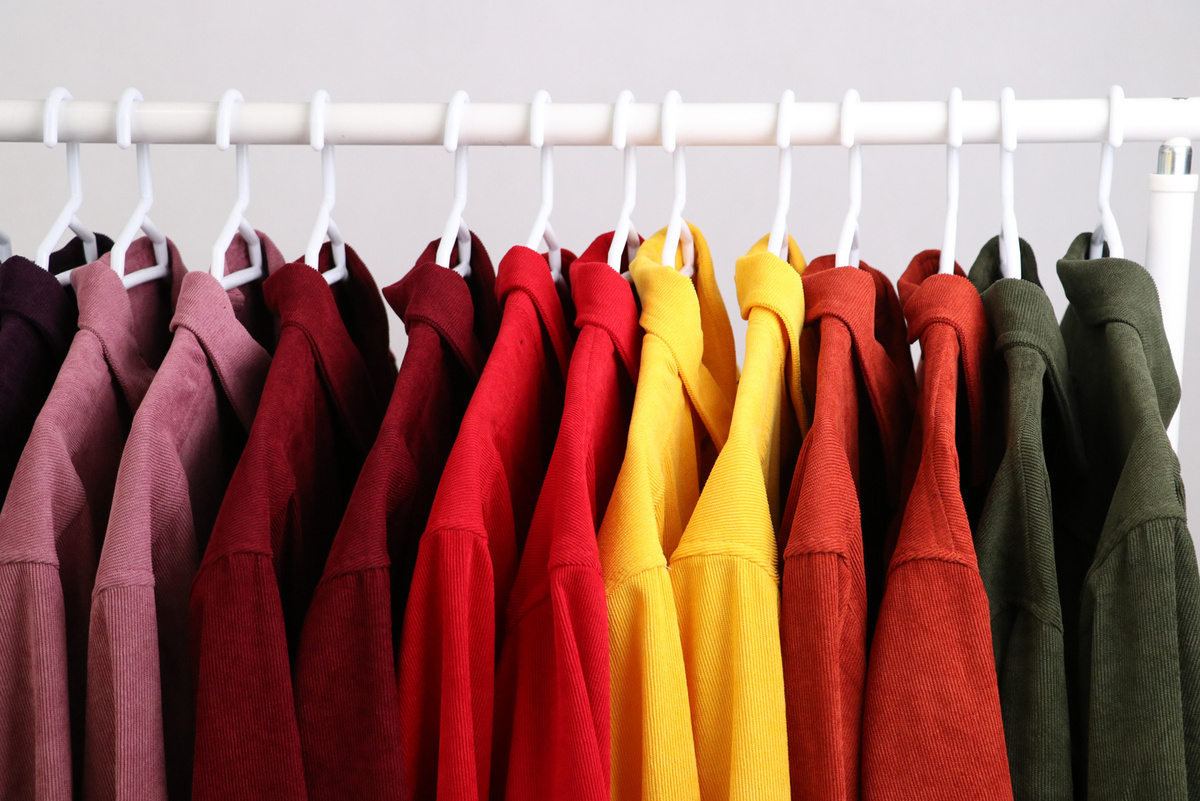 Red and Yellow Clothes Hanged on White Clothes Hanger